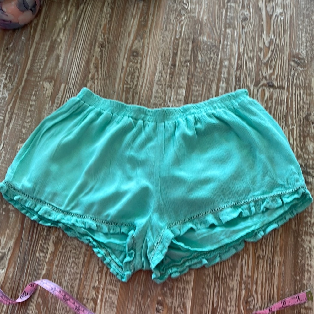 Cute mint green ruffle edged shorts.  Lined, but light and cute